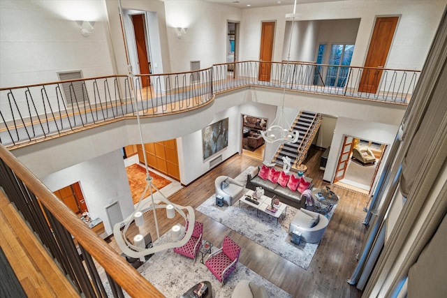 living room with hardwood / wood-style flooring and a high ceiling