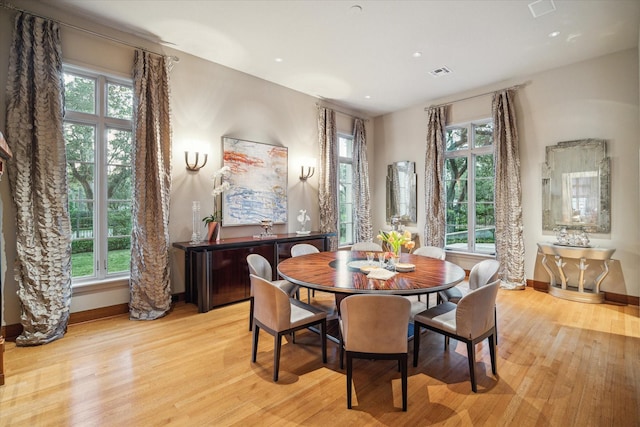 dining space with light hardwood / wood-style flooring