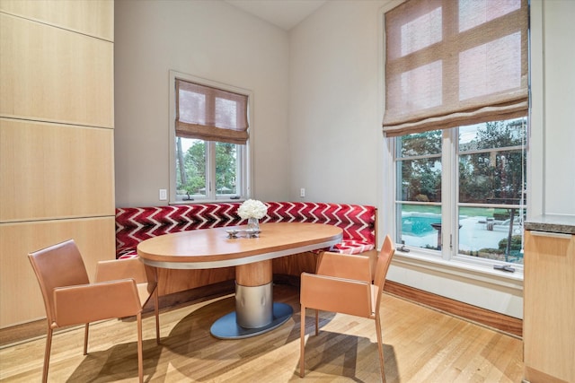 dining space with light wood-type flooring and breakfast area