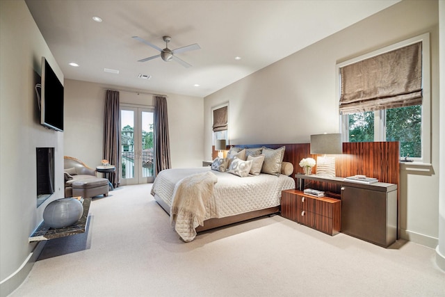 bedroom featuring light carpet, access to exterior, and ceiling fan