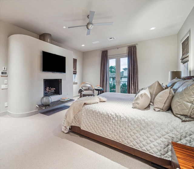 carpeted bedroom with ceiling fan and french doors