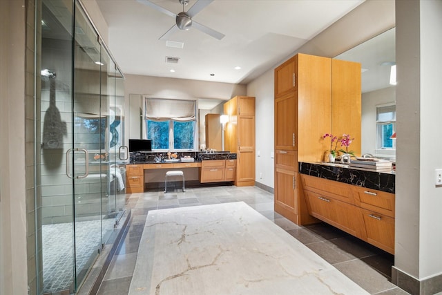 bathroom featuring vanity, an enclosed shower, and ceiling fan