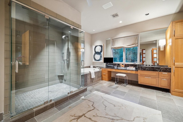 bathroom with vanity and separate shower and tub