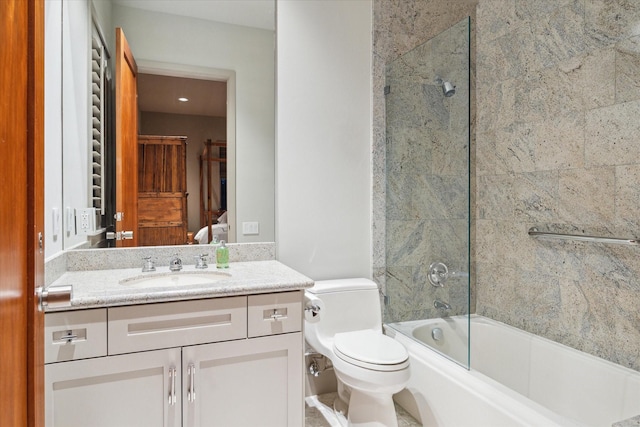 full bathroom featuring vanity, enclosed tub / shower combo, and toilet