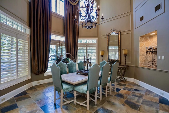 dining room featuring a high ceiling and an inviting chandelier