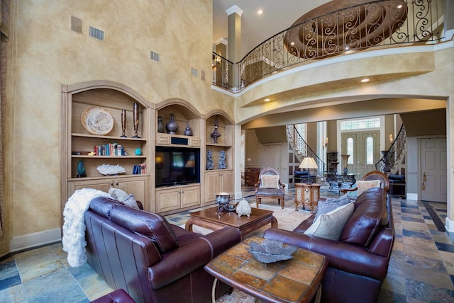 living room featuring built in features and a high ceiling