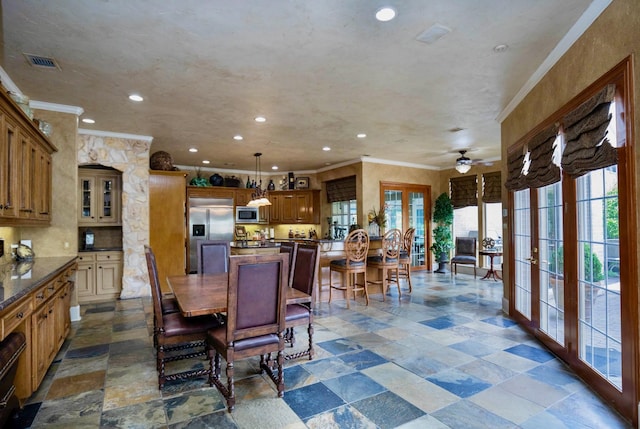 dining area featuring crown molding and french doors