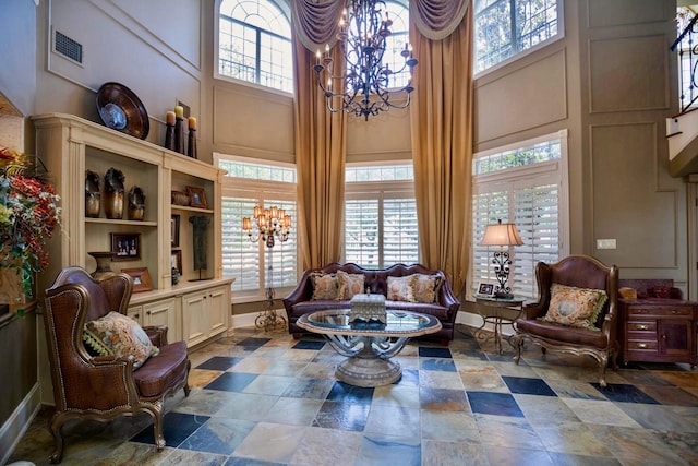 sitting room featuring a chandelier and a high ceiling