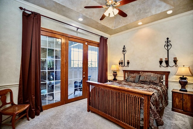 carpeted bedroom with french doors, crown molding, access to outside, a raised ceiling, and ceiling fan