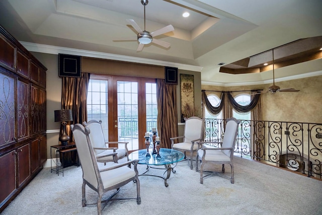 sitting room with crown molding, light carpet, ceiling fan, and a tray ceiling