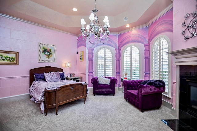 bedroom featuring crown molding, a tray ceiling, carpet floors, and a notable chandelier