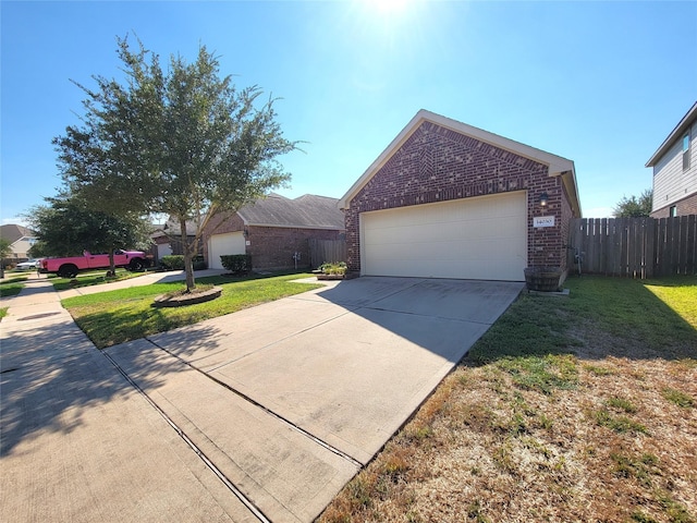 view of front of property with a garage and a front lawn