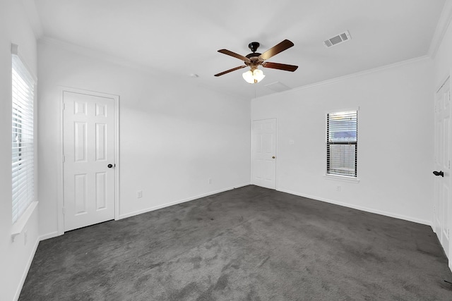 unfurnished room featuring ornamental molding, ceiling fan, and dark colored carpet