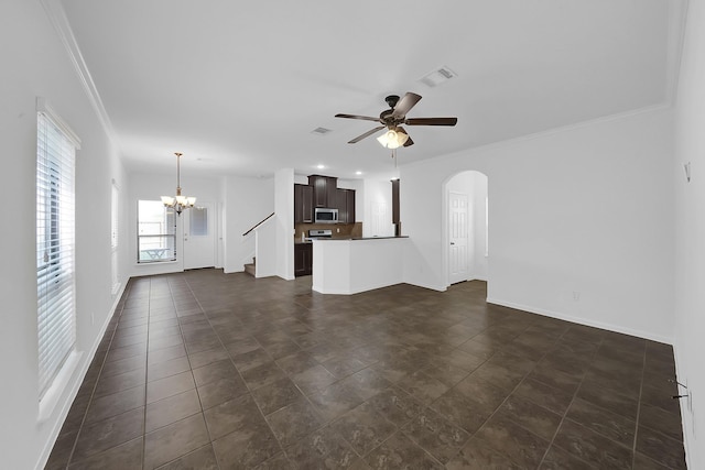 unfurnished living room with dark tile patterned floors, ornamental molding, and ceiling fan with notable chandelier