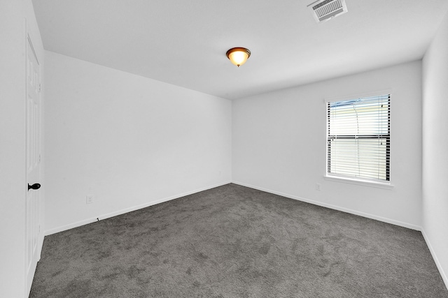 empty room featuring dark colored carpet