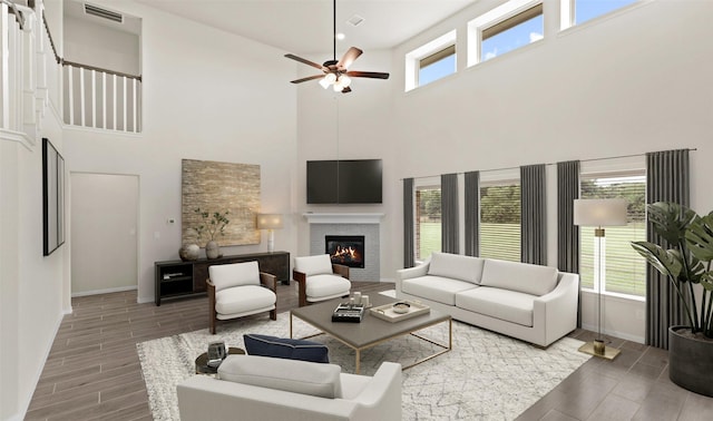 278 Peninsula Point Dr, Montgomery, TX 77356 - living room with wood tiled floors, ceiling fan, a high ceiling, and a glass covered fireplace