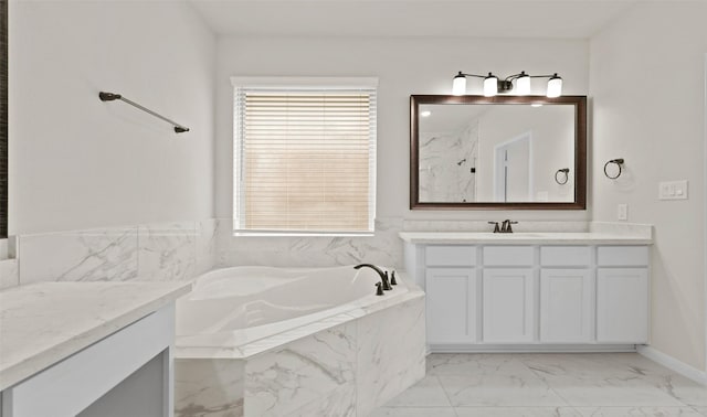 bathroom with vanity and a relaxing tiled tub