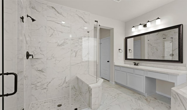 bathroom featuring a shower with door and vanity