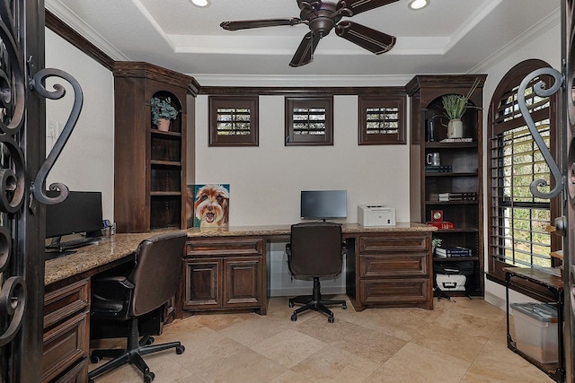 home office with crown molding, a tray ceiling, and ceiling fan