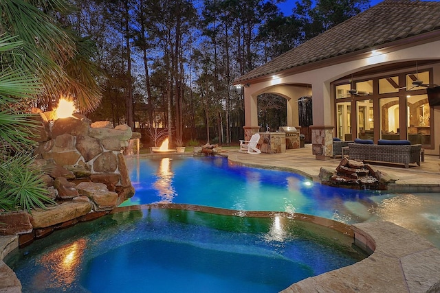 view of swimming pool with ceiling fan, area for grilling, an in ground hot tub, and a patio area