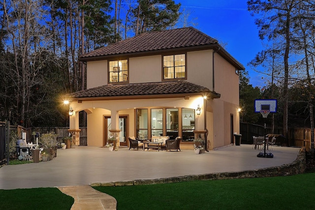 back of property with outdoor lounge area and a patio area