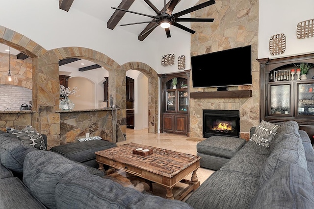 living room featuring a towering ceiling and a fireplace