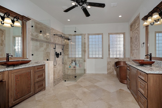 bathroom featuring vanity, ceiling fan, and tiled shower