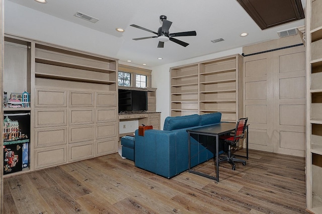 living room with hardwood / wood-style flooring and ceiling fan