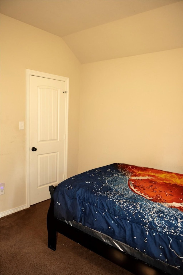 carpeted bedroom with lofted ceiling