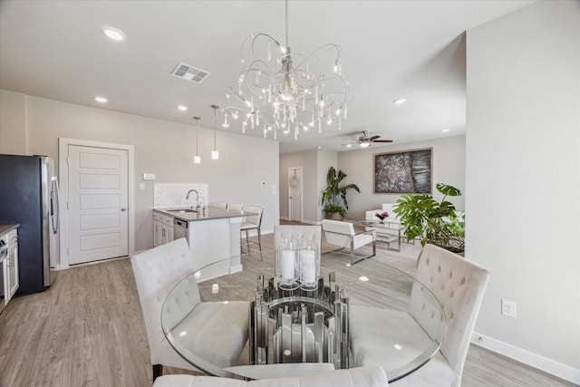 dining area with sink, ceiling fan, and light hardwood / wood-style flooring