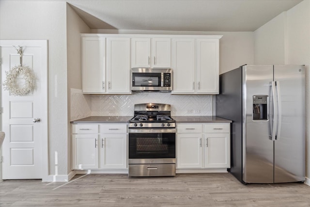 kitchen featuring white cabinetry, appliances with stainless steel finishes, decorative backsplash, and light hardwood / wood-style flooring