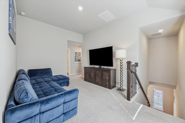 living room featuring lofted ceiling and light carpet