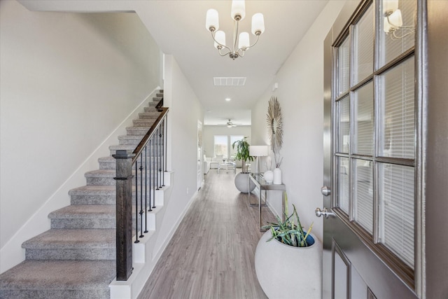 foyer entrance featuring hardwood / wood-style flooring and a chandelier