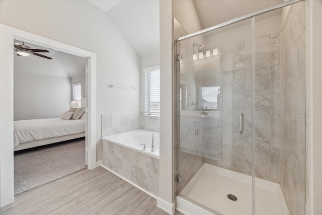 bathroom with ceiling fan, wood-type flooring, independent shower and bath, and vaulted ceiling