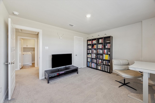 office with light colored carpet and washer / dryer