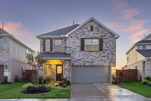 front facade featuring a yard and a garage