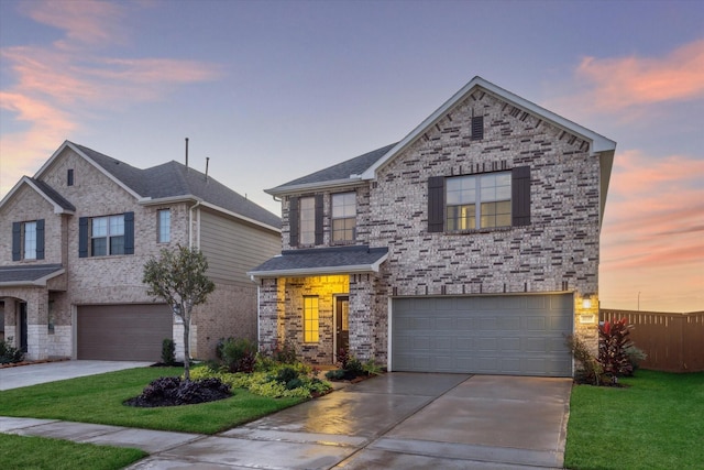 view of front of house featuring a garage and a yard