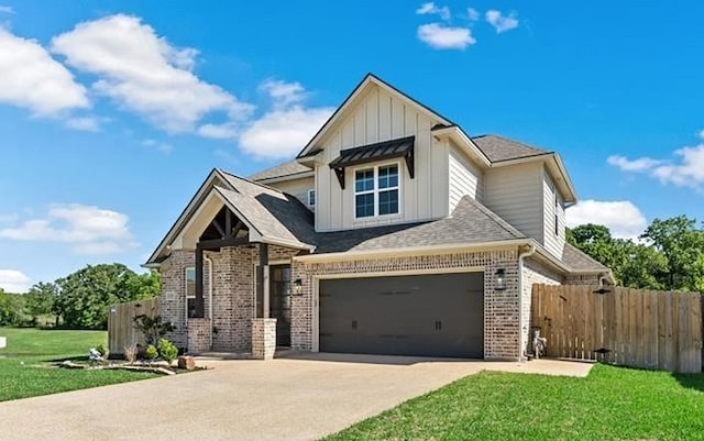 view of front of home featuring a garage and a front yard