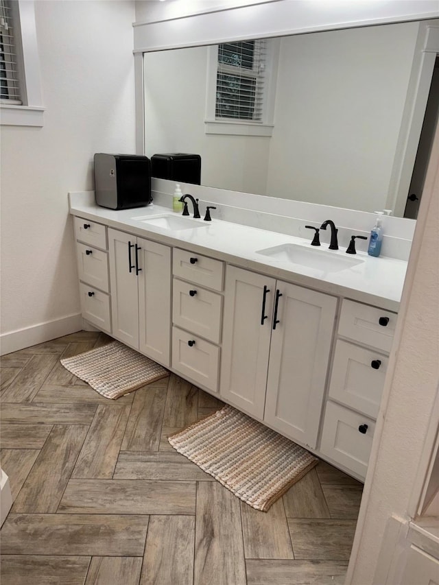 bathroom featuring parquet floors and vanity