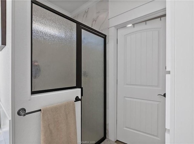 bathroom featuring a shower with door