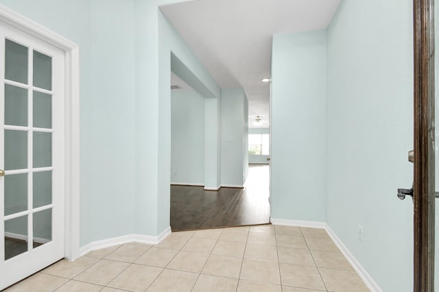 hall featuring light tile patterned floors