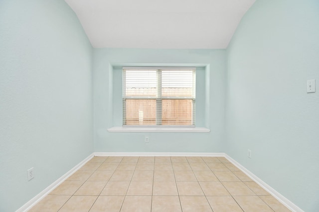 unfurnished room with lofted ceiling