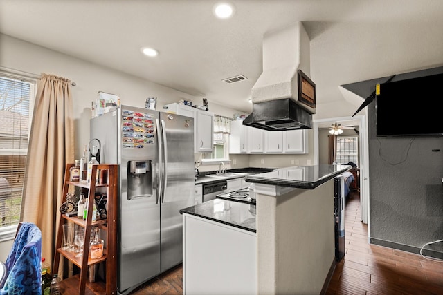 kitchen with sink, white cabinetry, stainless steel appliances, a healthy amount of sunlight, and a kitchen island