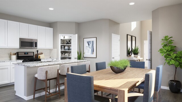 dining area with sink and dark hardwood / wood-style flooring