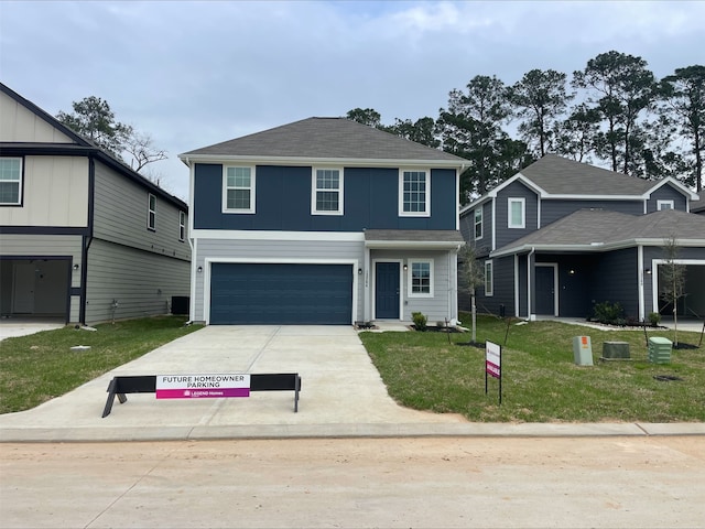 view of front of home featuring a garage, concrete driveway, and a front yard