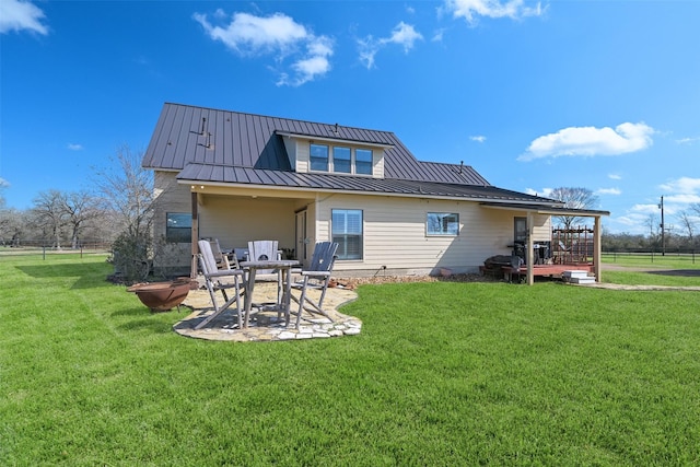 back of house featuring a lawn and a patio area