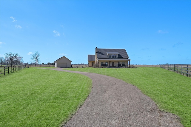 view of front facade featuring a rural view and a front yard