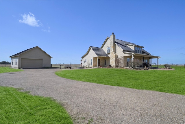 view of side of home featuring a garage, an outdoor structure, and a lawn