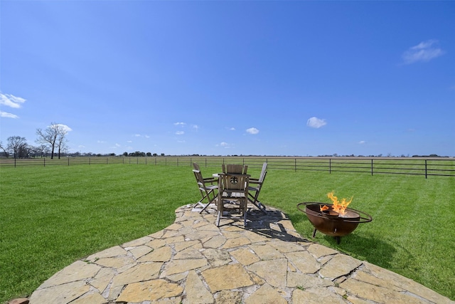 view of patio / terrace featuring a rural view and an outdoor fire pit