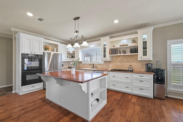 kitchen featuring sink, appliances with stainless steel finishes, white cabinets, and a kitchen island